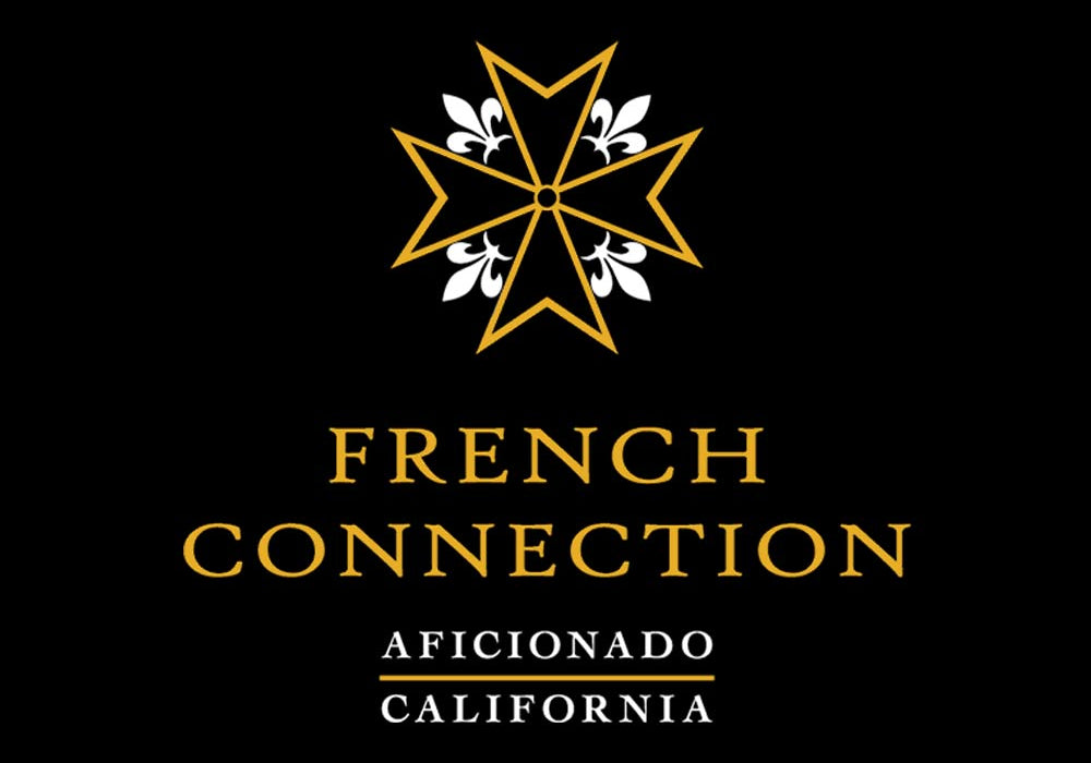 Ein goldener achtzackiger Stern über der Aufschrift FRENCH CONNECTION und ein Balken mit AFICIONADO in Gold, alles auf schwarzem Hintergrund.