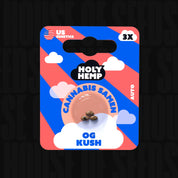 Holy Hemp OG Kush Auto Packung mit drei Samen im Fenster, rot-blauer Hintergrund mit US Genetics und 3X